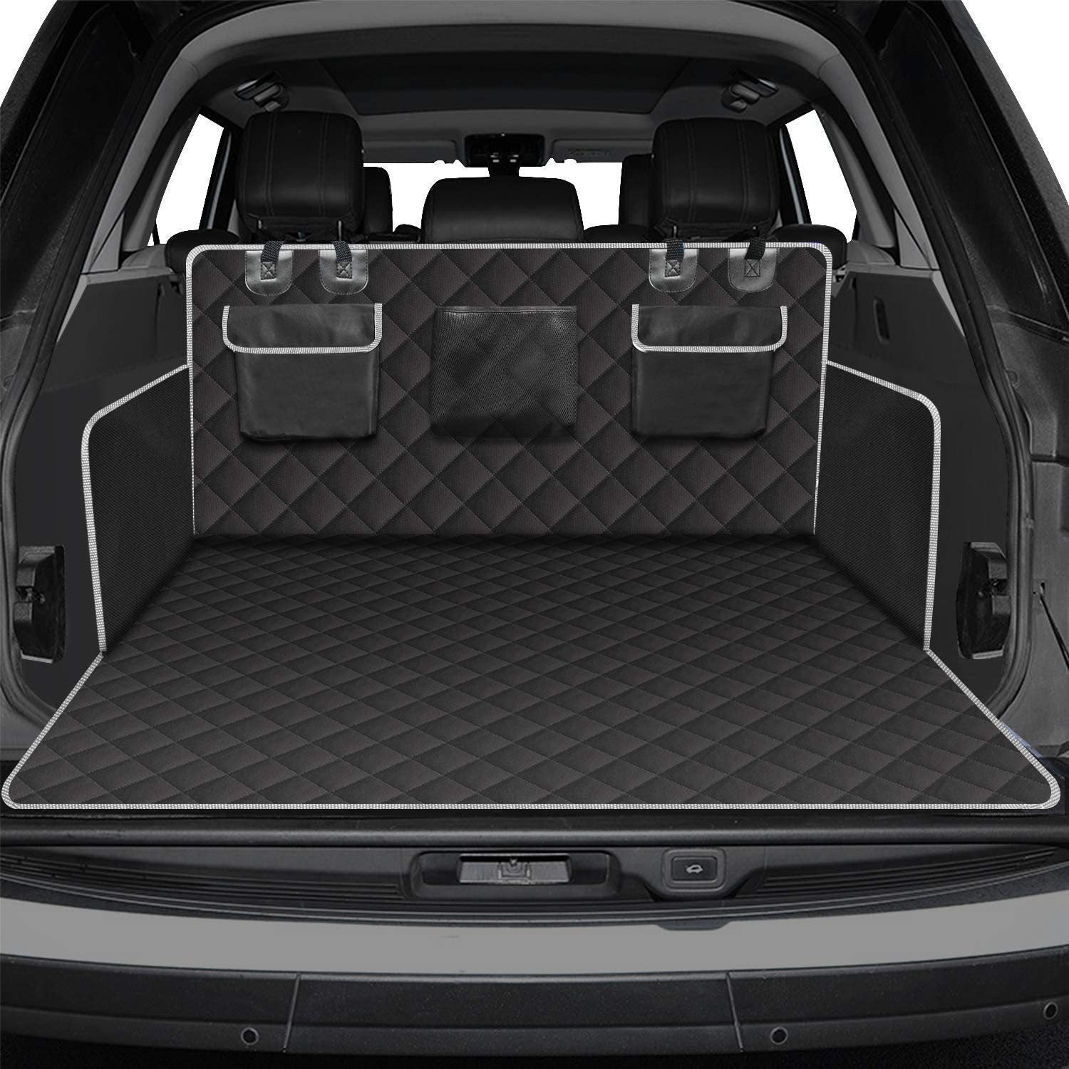 Car trunk with a black quilted cargo liner and storage bins.